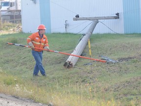 ACTO Electric worker Ken Sauchenk works to ground some down power lines. JOCELYN TURNER/DAILY HERALD-TRIBUNE/QMI AGENCY