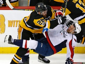 Pittsburgh Penguins' Ian Cole checks Washington Capitals' Justin Williams off the puck during Game 4 on May 3, 2017. (AP Photo/Gene J. Puskar)