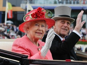 In this Thursday, June, 16, 2011 file photo Britain's Queen Elizabeth II with Prince Philip arrive by horse drawn carriage in the parade ring on the third day, traditionally known as Ladies Day, of the Royal Ascot horse race meeting at Ascot, England. Queen Elizabeth II's husband, Prince Philip, will stop carrying out public engagements this fall, Buckingham Palace announced Thursday May 4, 2017. (AP Photo/Alastair Grant, File)