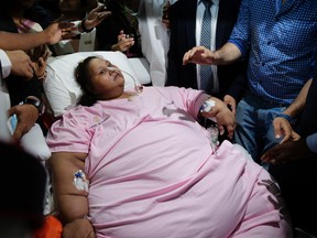 Egyptian woman Emam Ahmed who was undergoing weight-loss surgery at Mumbai’s Saifee Hospital is carried on a stretcher towards an ambulance on her way to the airport in Mumbai, India, Thursday, May 4, 2017. Emam Ahmed weighed about 500 kilograms when she was flown to Mumbai for treatment in February. (AP Photo/Rafiq Maqbool)
