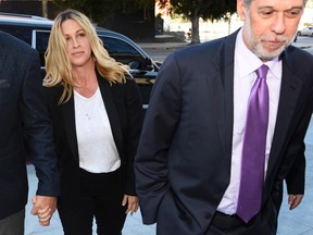 Singer Alanis Morissette, left, arrives with attorney Allen Grodsky at U.S. federal court for the sentencing in the embezzlement case of her former manager Jonathan Todd Schwartz, Wednesday, May 3, 2017, in Los Angeles. Schwartz pleaded guilty earlier this year after admitting he embezzled more than $7 million from the singer and other celebrities. (AP Photo/Chris Pizzello)