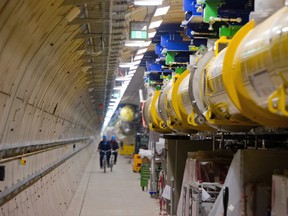 In this Feb. 18, 2015 file photo employees pass by the European XFEL laser in Hamburg. northern Germany. Scientists say they have switched on the world’s biggest X-ray laser, designed to capture images of structures and processes at the atomic level. The DESY research center near Hamburg, Germany, said Thursday that bringing the laser to life for the first time “marks a new era of research in Europe.” (Daniel Bockwoldt/dpa via AP)