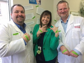 Ingersoll Nurse Practioner Led Clinic and Ingersoll Pharmasave show off green bandages supporting Mental Health Week and the #GetLoudOxford  initiative, From left Dom Ricciuto, Lisa Longworth and Rob Parsons. (HEATHER RIVERS, Sentinel-Review)