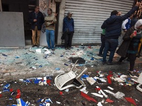 Egyptians gather by debris resulting from a blast which struck outside the Coptic Orthodox Patriarchate in Alexandria as worshippers attended Palm Sunday mass earlier on April 9, 2017. The Interior ministry said Coptic Pope Tawadros II was inside the church leading a Palm Sunday service when the suicide bomber was stopped by police outside and blew himself up. A church official said Tawadros had already left the church when the bombing took place. (MOHAMED EL-SHAHED/Getty Images)