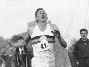In this May 6, 1954, file photo, Britain's Roger Bannister hits the tape to break the four-minute mile in Oxford, England. (The Associated Press)