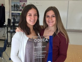 Kingston Collegiate students Jane Smallman, left, and Erin Peterson are seen with their business award from the International Career Development Conference in Anaheim, Calif.  (Ian MacAlpine/The Whig-Standard)