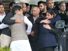 Family members of slain taxi driver Vijay Bhatia leave Westview Funeral Home following his funeral on Wednesday. (MORRIS LAMONT, The London Free Press_