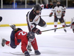 Airdrie Xtreme forward Jake Neighbours (14) collides with Lethbridge's Val Matteoti Golden Hawks' Carson Dyck (12) in the division quarter-final of the Alberta Major Bantam triple-A playoffs at the Ron Ebbesen Arena on Feb. 18, 2016, in Airdrie, Alta. Neighbours was taken fourth overall by the Edmonton Oil Kings in Thursday's WHL bantam draft. (File)