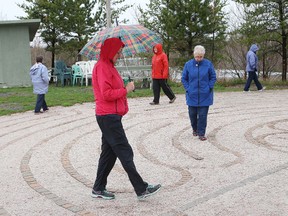 A group of people walk at the St. Peter's United Church labyrinth during World Labyrinth Day at the grotto on Lourdes Street on May 7, 2016. The labyrinth is a path of prayer and walking meditation. John Lappa/Sudbury Star