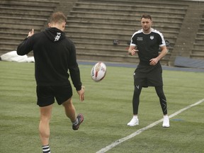 Toronto Wolfpack half back Rhys Jacks (left) kicks a ball to teammate Ryan Brierley at practice at Monarch Park in preparation for their first home match at Lamport Stadium on Saturday. (Jack Boland/Toronto Sun)