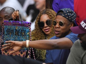Beyonce and Jay Z watch during the first half in Game 7 of an NBA basketball first-round playoff series between the Los Angeles Clippers and the Utah Jazz, Sunday, April 30, 2017, in Los Angeles. (AP Photo/Mark J. Terrill)