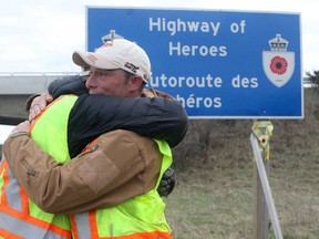 PETE FISHER/POSTMEDIA NETWORK
Afghanistan veteran Collin Fitzgerald hugs fellow vet Nick Kerr after completing their journey on in Trenton. They were joined by Kerri Tadeau in the effort that took most of April, spending 11.5 hours a day cleaning up interchanges along the Highway of Heroes, from Keele Street in Toronto to Trenton.