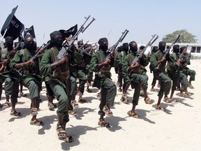 In this Thursday, Feb. 17, 2011 file photo, hundreds of newly trained al-Shabab fighters perform military exercises in the Lafofe area some 18 km south of Mogadishu, in Somalia. The U.S. military said Friday, May 5, 2017 that a service member has been killed in Somalia during an operation against the extremist group al-Shabab as the United States steps up its fight against the al-Qaida-linked organization. (AP Photo/Farah Abdi Warsameh, File)