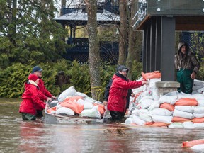 Sandbags being moved by boat to a flooded property in Rockland during the May floods.
