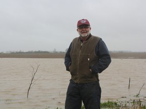 His black turtle bean fields under water, farmer Tom Oegema, near Talbotville, says he's had enough of the Southwestern Ontario deluge that he believes will cost him up to 10 days waiting to get back on his fields once the rain stops. (Laura Broadley/Postmedia News)