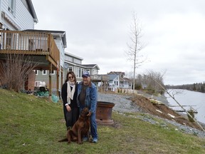 Roger and Carole Carriere, with their dog Zeus, don't feel comfortable sleeping in their home anymore. They say that the erosion on the Mattagami River is making it unsafe.