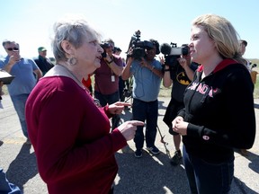 Emerson resident Joyce Dayton, left, confronts Conservative MP Michelle Rempel following a press conference to discuss the increase of illegal crossings near Emerson, Man., Friday, May 5, 2017. THE CANADIAN PRESS/Trevor Hagan