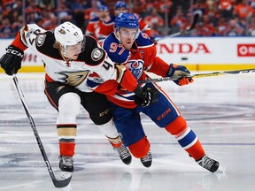 Anaheim Ducks' Hampus Lindholm, left, from Sweden, and Edmonton Oilers' Connor McDavid battle for the puck during second period NHL hockey round two playoff action in Edmonton, Wednesday, May 3, 2017.