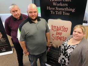 Michael Hurley, left, and Mike Rodrigues of the Canadian Union of Public Employees, and Amanda Poisson, a registered practical nurse, say assaults against health-care workers need to be treated more seriously. (Elliot Ferguson/The Whig-Standard)