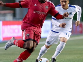 Ottawa's Eddie Edward takes control of the ball from Edmonton's Dustin Corea as the Ottawa Fury FC (red) met up with FC Edmonton during the first leg of the Canadian Championship at TD Place in Ottawa Wednesday (May 3, 2017) evening.