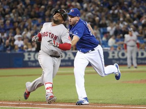 Blue Jays pitcher Joe Biagini (right) tags out Pablo Sandoval of the Red Sox during MLB action in Toronto on April 20, 2017. (Tom Szczerbowski/Getty Images)