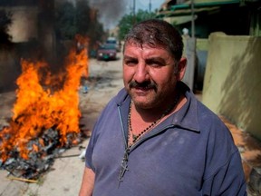 FADEL SENNA/Getty Images
An Iraqi Christian stands by a fire burning garbage outside his house on Friday following his return to his hometown in the predominantly Christian Iraqi town of Qaraqosh (Hamdaniya), which lies some 30 kilometres east of the northern city of Mosul. Qaraqosh was retaken by Iraqi forces in October 2016, after it had been ravaged by Islamic State (IS) group fighters who seized it in June 2014 as they rampaged across parts of northern Iraq.
