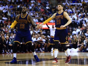 Cavaliers' LeBron James (left) congratulates teammate Kyle Korver in Cleveland's 115-94 win in Game 3 on Friday. (Getty Images)