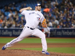 Blue Jays pitcher Joe Biagini delivers a pitch right-handed on April 13, 2017. He says he might try pitching left-handed in the future. Then again, Biagini is a noted jokester. (TOM SZCZERBOWSKI/Getty Images files)