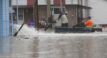Gatineau emergency workers helped the people of Rue Saint-Louis area in Gatineau Friday May 5, 2017. More rain has caused water to rise and flooded more people out of their homes. Two men paddle down Rue Oscar Friday.  Tony Caldwell