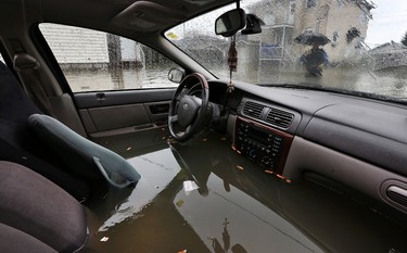 Gatineau emergency workers helped the people of Rue Saint-Louis area in Gatineau Friday May 5, 2017. More rain has caused water to rise and flooded more people out of their homes. An abandoned car full of water on Rue René in Gatineau Friday. Tony Caldwell, Postmedia