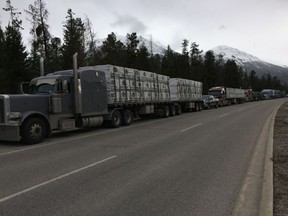 Trucks are lined up on Highway 16 west of Jasper blocked to traffic because of a rock slide. (Janet French/Edmonton Sun)