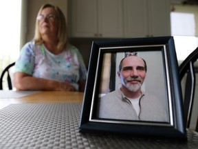 Mary Jane Mackinnon sits in the kitchen of her Belleville home with a framed photo of her son, 49-year-old Kevin Blair Phillips in front of her on Saturday May 6, 2017 in Belleville, Ont. Phillips went missing from his Vancouver apartment in September of last year. Tim Miller/Belleville Intelligencer/Postmedia Network