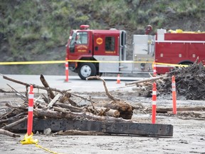 Flood debris is seen on the road in Cache Creek, B.C., May 6, 2017. The small B.C. community was hit this week with flooding from melting snow pack. THE CANADIAN PRESS/Jonathan Hayward