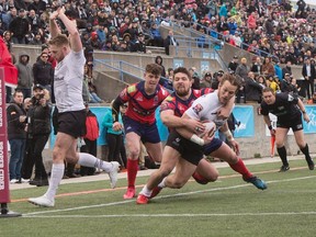Wolfpack’s Ryan Burroughs (right) scores a try against Oxford during its win in its inaugural home opener in Kingstone Press League 1 rugby action at Lamport Stadium yesterday. (Chris young/THE CANADIAN PRESS)
