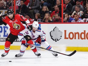 Senators captain Erik Karlsson battles for the loose puck with Rangers forward Mats Zuccarello during Game 5 of the NHL's Eastern Conference Second Round playoff series at Canadian Tire Centre in Ottawa on Saturday, May 6, 2017. (Jana Chytilova/Freestyle Photography/Getty Images)