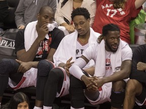 Raptors' Serge Ibaka (left), DeMar DeRozan (centre) and DeMarre Carroll watch the action from the bench as they take on the Cavaliers during the second half of Game 3 of the NBA's second round playoff series in Toronto on Friday, May 5, 2017. (Fred Thornhill/The Canadian Press)