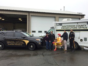 In this undated photo released by the Hunterdon County Prosecutor's Office, Detective Dean Cerdeira, second from right, of the Hunterdon County Prosecutor's Office, and Detective Thomas Hash, right, of the Clinton Township Police Department, pose with a recovered Ronald McDonald statue along with Diane, left, and Phillip Koury, the owners of the statue, in Clinton, N.J. Hunterdon County prosecutors say the 250-pound fiberglass statue of the clown character sitting on a bench was taken from the McDonald's in Clinton. They announced Friday, May 5, 2017, that it had been found but declined further comment. (Paul Approvato/Hunterdon County Prosecutor's Office via AP)