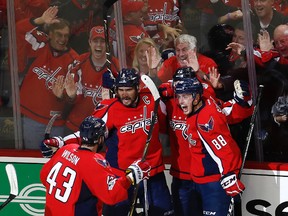 Capitals captain Alex Ovechkin (8) celebrates scoring a goal against the Penguins with teammates Tom Wilson (43), Kevin Shattenkirk (22), and Nate Schmidt (88), during the third period of Game 5 in the second round of the NHL playoffs in Washington on Saturday, May 6, 2017. (Carolyn Kaster/AP Photo)