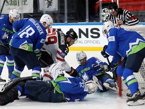 Canada's Nate MacKinnon, centre up, scores a goal past Slovenia's Gasper Kroselj, centre down, during the Ice Hockey World Championships group B match between France and Norway in the AccorHotels Arena in Paris, France, Sunday, May 7, 2017. (AP Photo/Petr David Josek)