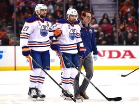 Andrej Sekera #2 of the Edmonton Oilers is helped off the ice by Milan Lucic #27 and a trainer during the first period against the Anaheim Ducks in Game 5 of their Stanley Cup playoff series on Friday May 5, 2017. (Harry How/Getty Images)