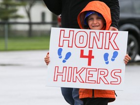Five-year-old Carter Boomhouwer holds up a sign at the annual Hike For Hospice walk on Sunday May 7, 2017 in Picton, Ont.  Tim Miller/Belleville Intelligencer/Postmedia Network