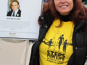 Carol Charlton, with a photo of her father John Charlton who died due to workplace contact with asbestos, led the Steps for Life walk. (NEIL BOWEN/The Observer)