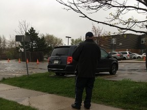 A parking enforcement officer hands out tickets in Mississauga on Friday, May 5, 2017. (Joe Warmington/Toronto Sun)