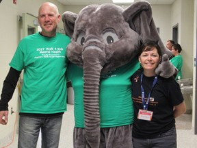 Paul VandenEngel and Denise VandenEngle pose with "the elephant in the room' at the Walk 4 Kids Mental Health event at Molly Brant Elementary School on Saturday. (Steph Crosier/The Whig-Standard)