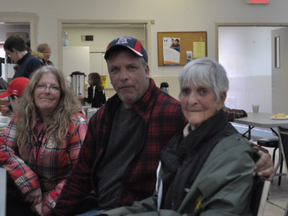 Pam Komm, 82, sits with family members at the Pontiac community centre Sunday, just moments after evacuating her home. DYLAN C. ROBERTSON / POSTMEDIA