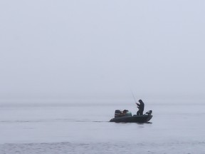 A lone fisherman braves an early-morning misting rain during the Kiwanis Walleye World Fishing Derby on Saturday May 6, 2017 in Belleville, Ont.  Tim Miller/Belleville Intelligencer/Postmedia Network