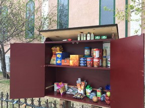 A community cupboard is seen in Winnipeg, Man. in this undated handout photo. A couple who've opened a community pantry outside their home in a poor Winnipeg neighbourhood say they could have started a community library, but the neighbours who knock on their door aren't looking for War and Peace. THE CANADIAN PRESS/HO, Kelly Hughes