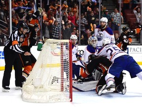 Oilers goalie Cam Talbot gets piled on as the Ducks scored with fifteen seconds left to tie the score in Game 5. (Getty Images)