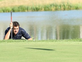 A golfer eyes the flag from the apron bordering the ninth green at Northern Bear Golf Course southeast of Edmonton, which has recently been purchased out of receivership. (File)