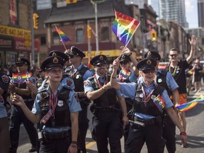 Hamilton police officers march along the parade route during the annual Pride Parade in Toronto on Sunday, July 3, 2016. (THE CANADIAN PRESS/PHOTO)